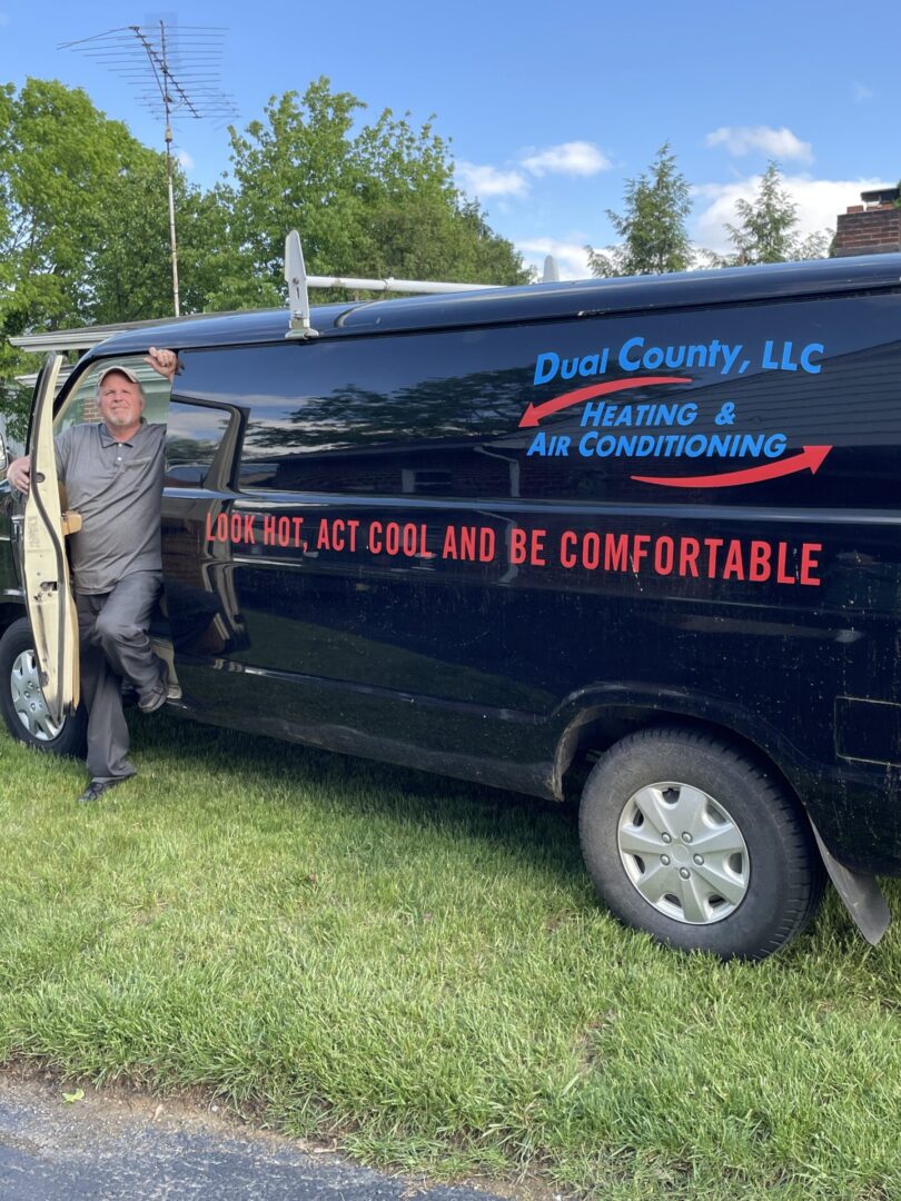 A man standing in front of an air conditioning van.